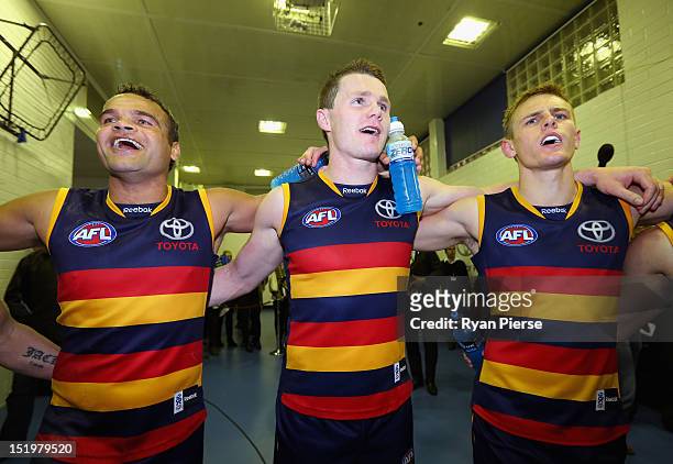 Graham Johncock of the Crows and Patrick Dangerfield of the Crows sing the club song after the AFL Second Semi Final match between the Adelaide Crows...