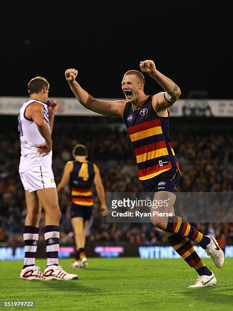 Sam Jacobs of the Crows celebrates on the final siren as Aaron Sandilands of the Dockers looks dejected during the AFL Second Semi Final match...
