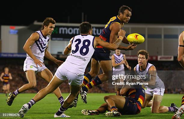 Graham Johncock of the Crows is tackled by Michael Walters of the Dockers during the AFL Second Semi Final match between the Adelaide Crows and the...