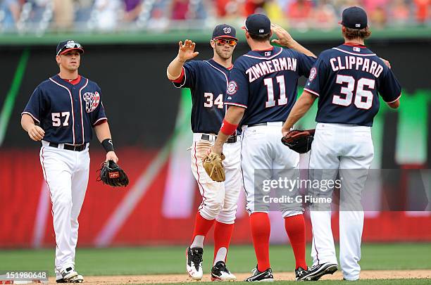 Bryce Harper of the Washington Nationals celebrates with Ryan Zimmerman after a 2-1 victory against the Chicago Cubs at Nationals Park on September...