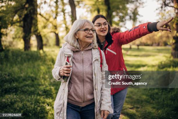 family time in nature - grandmother walking stock pictures, royalty-free photos & images