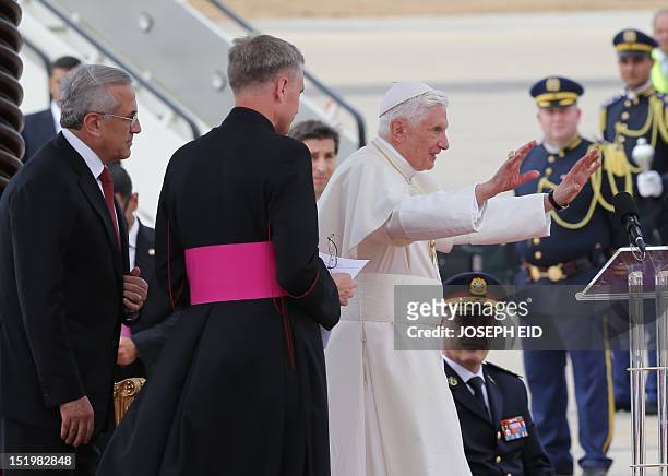Lebanese President Michel Sleiman stands behind Pope Benedict XVI during an official welcoming ceremony upon the latter's arrival at Beirut's...