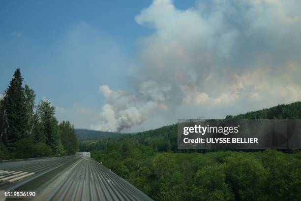 Smoke from a wildfire is seen in the distance near Sheraton , British Colombia, Canada, taken from a passenger train on the Prince George - Prince...