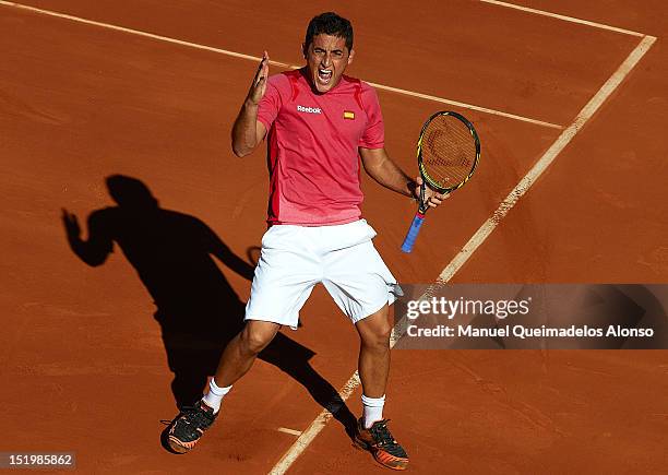 Nicolas Almagro of Spain celebrates a point over John Isner of the United States States during day one of the semi final Davis Cup between Spain and...