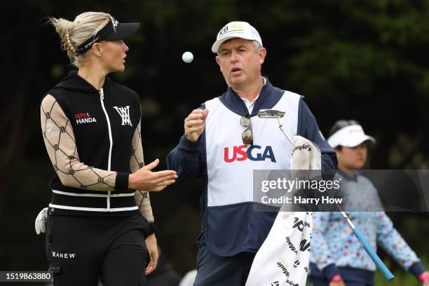 Charley Hull of England tosses a ball to her caddie Adam Woodward on the third hole during the first round of the 78th U.S. Women's Open at Pebble...