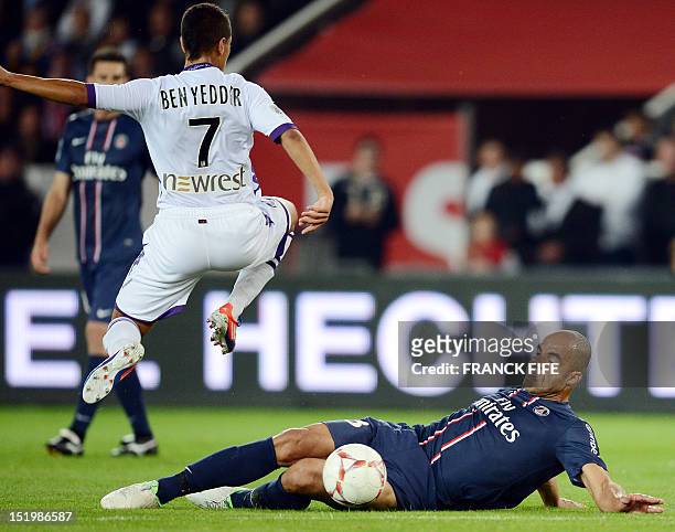 Toulouse's French midfielder Wissam Ben Yedder is tackled by Paris Saint-Germain's Brazilian defender Alex Rodrigo Dias da Costa during the French L1...