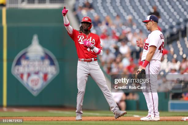 Elly De La Cruz of the Cincinnati Reds celebrates toward the dugout in front of first baseman Joey Meneses of the Washington Nationals after hitting...