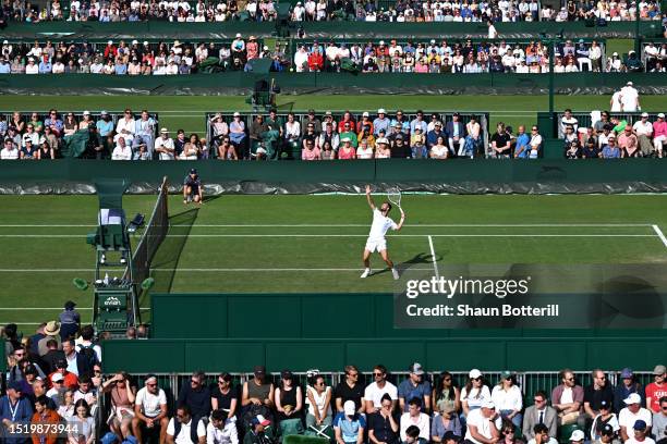 Corentin Moutet of France serves against Roman Safiullin in the Men's Singles second round match as spectators watch on during day four of The...