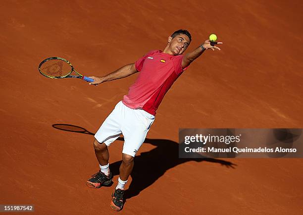 Nicolas Almagro of Spain serves the ball to John Isner of the United States during day one of the semi final Davis Cup between Spain and the United...