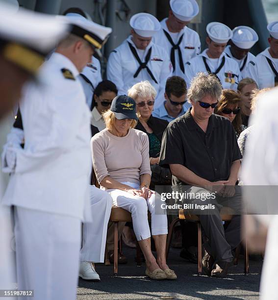 In this handout from NASA, Carol Armstrong , wife, Eric "Rick" Armstrong, son of Neil Armstrong , and other family members bow their heads during...