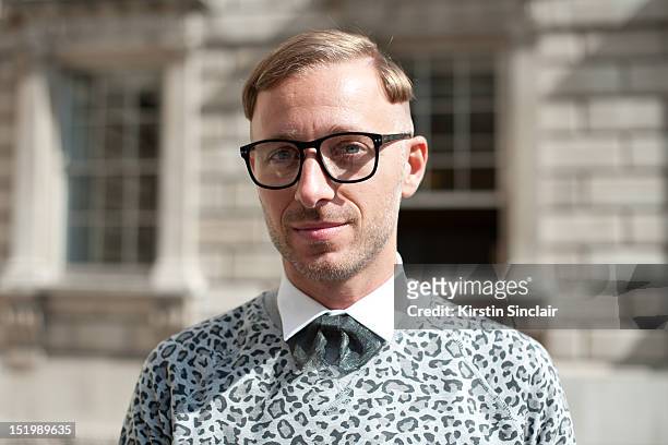 Francsesco Adams-Facchini fashion consultant and blogger wearing Lanvin shirt, H and M jumper and glasses and a Fendi Bow tie on day 1 of London...