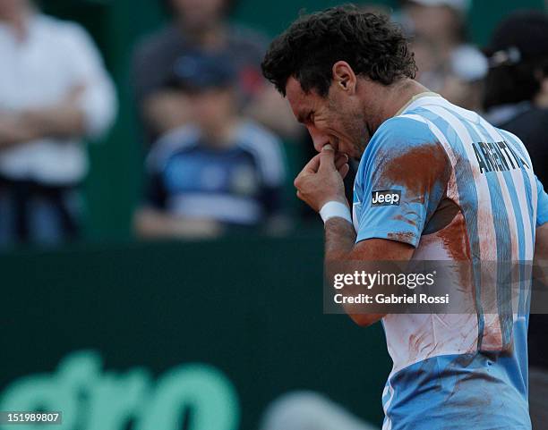 Juan Monaco of Argentina leaves the court after being defeated by Tomas Bedych during the second Davis Cup semi-final match between Argentina and...