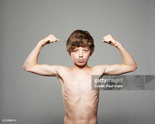 teenage boy showing muscles - slim stock pictures, royalty-free photos & images