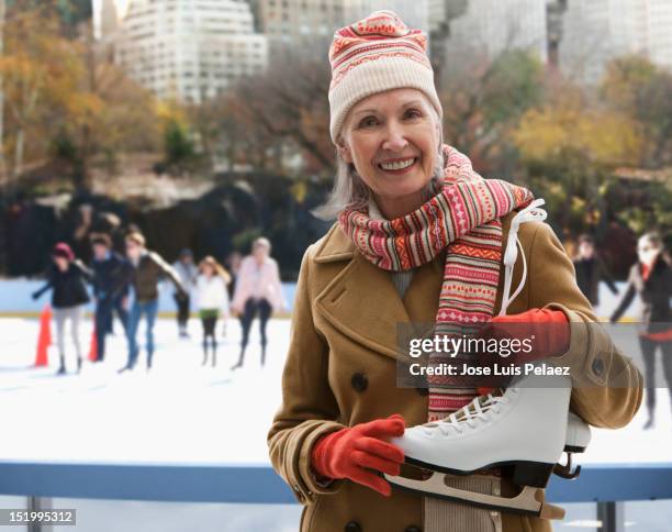 senior woman at ice skating rink - ice skate fotografías e imágenes de stock