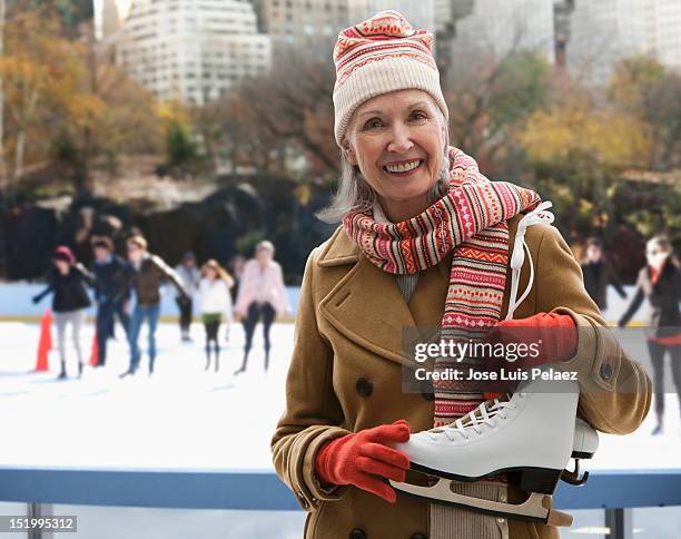 senior woman at ice skating rink - hockey skate stock pictures, royalty-free photos & images