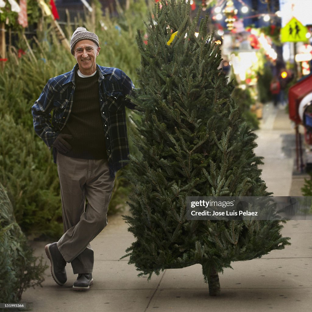 Senior man with Christmas tree