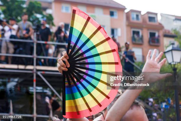 detail of a fan with rainbow colors, celebrating gay pride. concept of celebration, freedom, homosexuality, respect, lesbian, transgender. - leque - fotografias e filmes do acervo