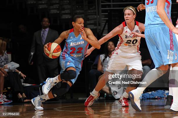 Armintie Price of the Washington Mystics drives against Natalie Novosel of the Atlanta Dream at the Verizon Center on September 14, 2012 in...