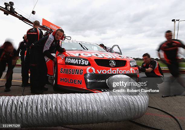 Jamie Whincup driver of the Team Vodafone Holden comes in for a pit stop during qualifying for the Sandown 500, which is round 10 of the V8 Supercars...