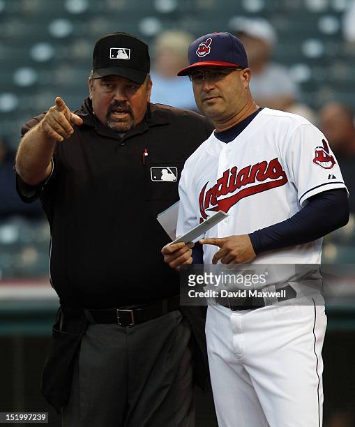 Manager Manny Acta of the Cleveland Indians talks with home plate umpire Wally Bell before the start of a game against the Detroit Tigers on...