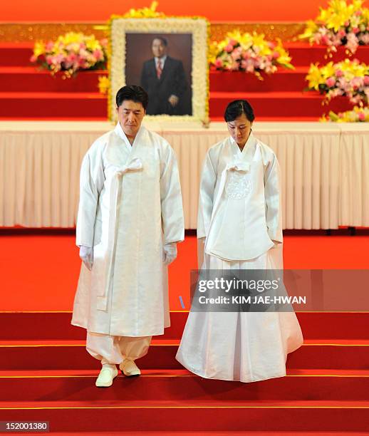 Moon Guk Jin , Unification Church founder Sun Myung Moon's son and leader of businesses operated by the church and his wife attend Moon's funeral...