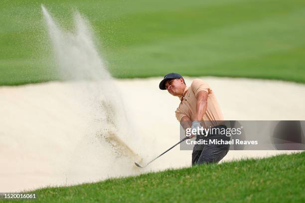 Cameron Champ of the United States plays a shot from a bunker on the 13th hole during the first round of the John Deere Classic at TPC Deere Run on...