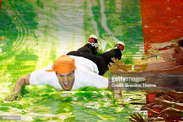 Singer Johnny Ruffo slides down slime during the Nickelodeon Slimefest 2012 evening show at Hordern Pavilion on September 15, 2012 in Sydney,...
