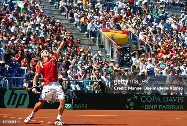 David Ferrer of Spain serves the ball to Sam Querrey of the United States during day one of the semi final Davis Cup between Spain and the United...