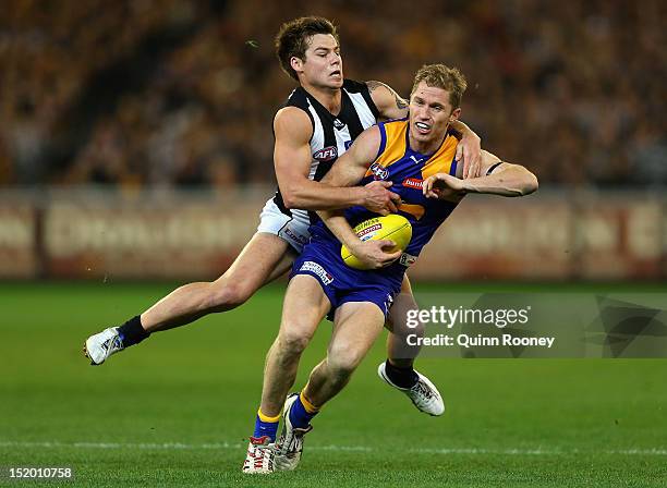 Adam Selwood of the Eagles is tackled by Jamie Elliott of the Magpies during the first AFL Semi Final match between the Collingwood Magpies and the...