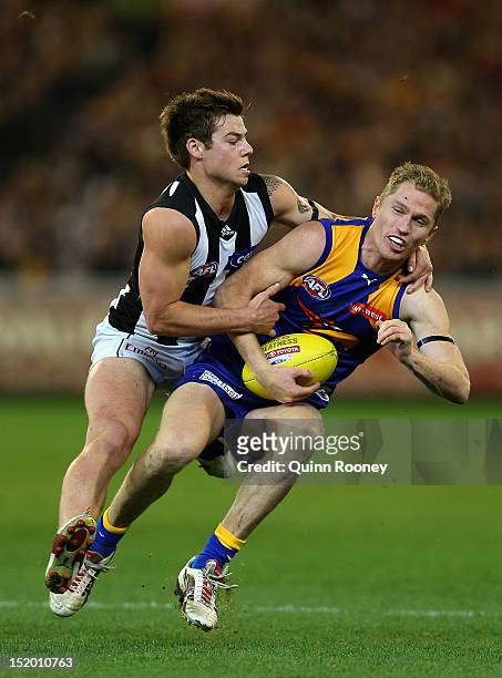 Adam Selwood of the Eagles is tackled by Jamie Elliott of the Magpies during the first AFL Semi Final match between the Collingwood Magpies and the...