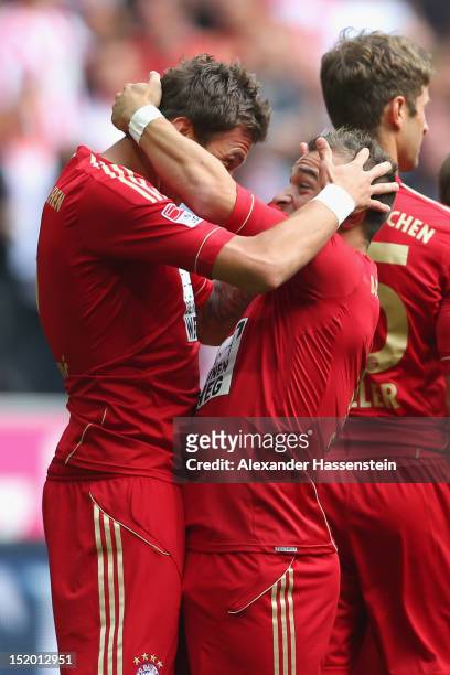 Mario Mandzukic of Muenchen celebrates scoring the opening goal with his team mate Xherdan Shaqiri during the Bundesliga match between FC Bayern...
