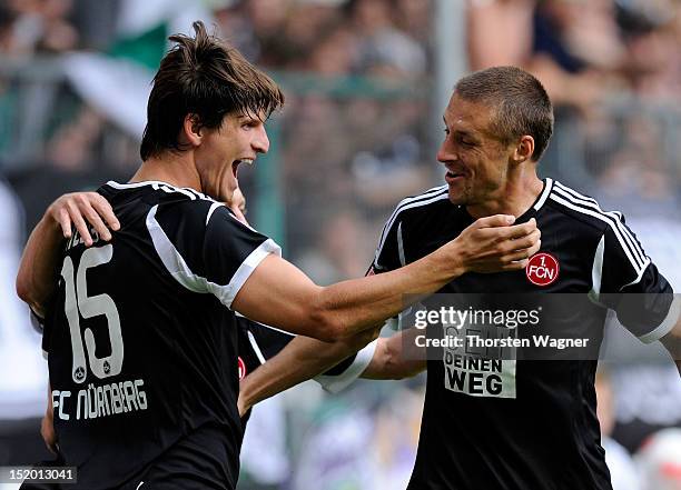 Timm Klose and his team mate Timmy Simons of Nuernberg celebrates after scoring her teams first goal during the Bundesliga match between Borussia...