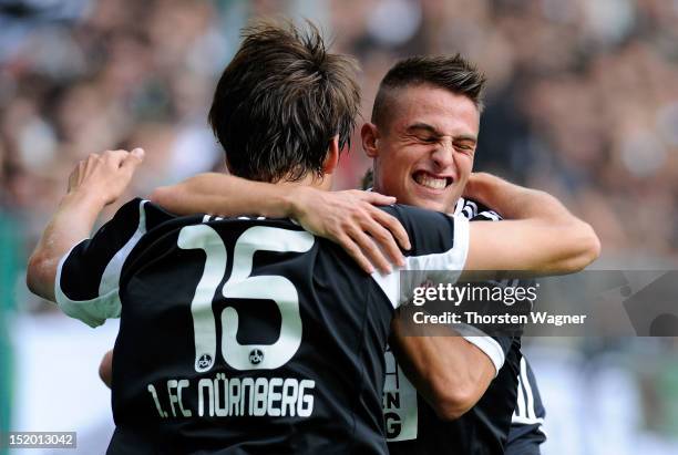 Timm Klose and his team mate Robert Mak of Nuernberg celebrates after scoring her teams first goal during the Bundesliga match between Borussia...