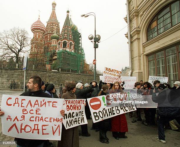 Relatives of hostages held by Chechen rebels in a Moscow theater hold banners reading "Stop the war in Chechnya" and "Do everything to save our...