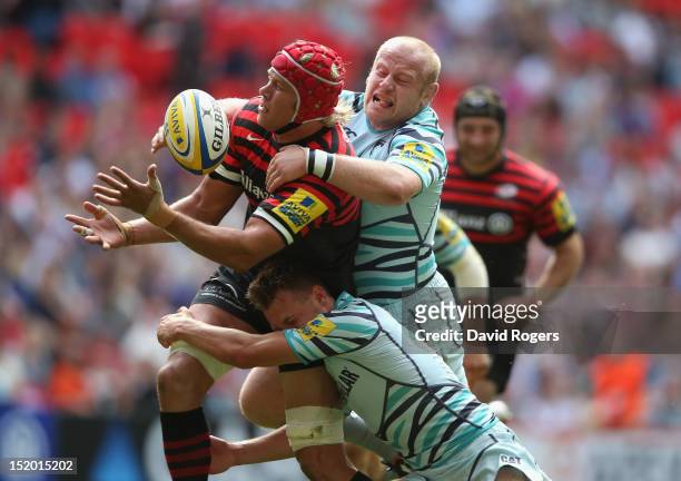 Mouritz Botha of Saracens is tackled by Dan Cole and Sam Harrison during the Aviva Premiership match between Saracens and Leicester Tigers at Wembley...