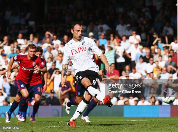 Dimitar Berbatov of Fulham shoots and scores his sides second goal from the penalty spot during the Barclays Premier League match between Fulham and...