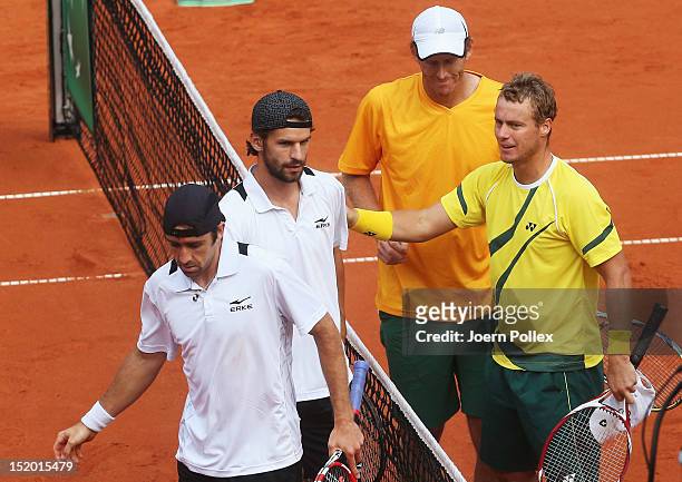Benjamin Becker and Philipp Petzschner of Germany shake hands with Chris Guccione and Lleyton Hewitt of Australia after loosing their doubles match...