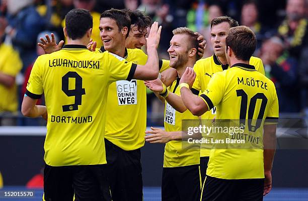 Jakub Blaszczykowski of Dortmund celebrates with team mates after scoring his teams second goal during the Bundesliga match between Borussia Dortmund...