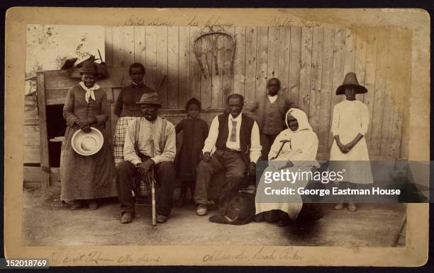 Portrait of American abolitionist Harriet Tubman as she poses with her family, friends, and neighbors on her porch, Auburn, New York, mid to late...