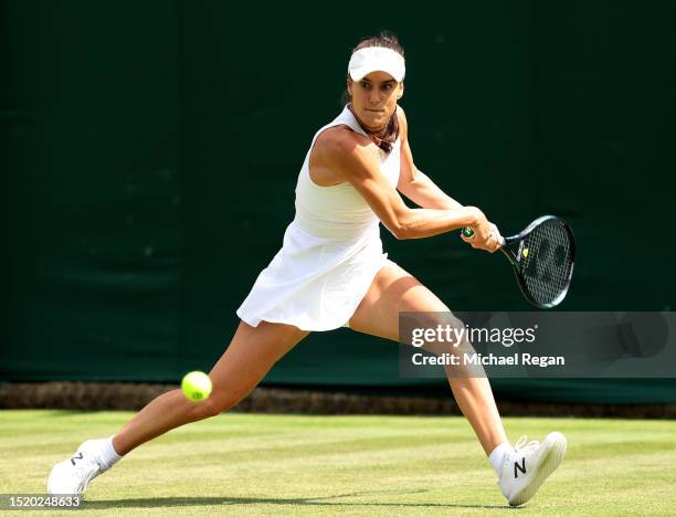 Sorana Cirstea of Romaniaplays a backhand against Jelena Ostapenko of Latvia in the Women's Singles second round match during day four of The...