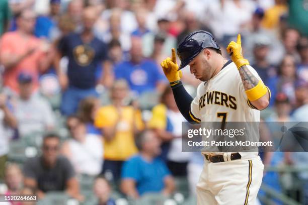 Victor Caratini of the Milwaukee Brewers celebrates after hitting a solo home run against the Chicago Cubs in the eighth inning at American Family...