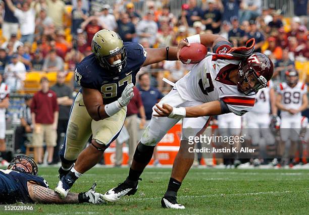 Logan Thomas of the Virginia Tech Hokies is sacked by Bryan Murphy and Aaron Donald of the Pittsburgh Panthers during the game on September 15, 2012...
