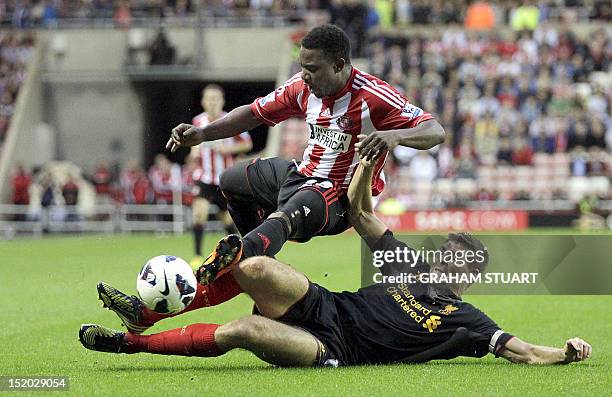 Sunderland's Beninese midfielder Stephane Sessegnon vies with Liverpool's English midfielder Steven Gerrard during the English Premier League...