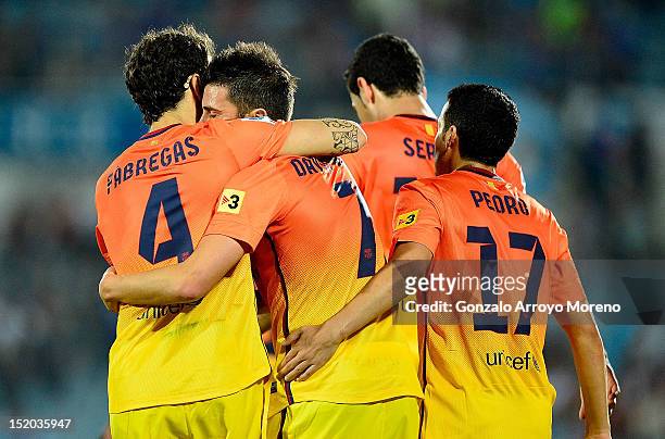 David Villa of FC Barcelona celebrates scoring their fourth goal with teammates Cesc fabregas and Pedro Rodriguez Ledesma during the La Liga match...