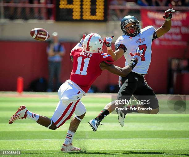 Wide receiver Julian Jones of the Arkansas State Red Wolves and cornerback Andrew Green of the Nebraska Cornhuskers miss getting their hands on a...