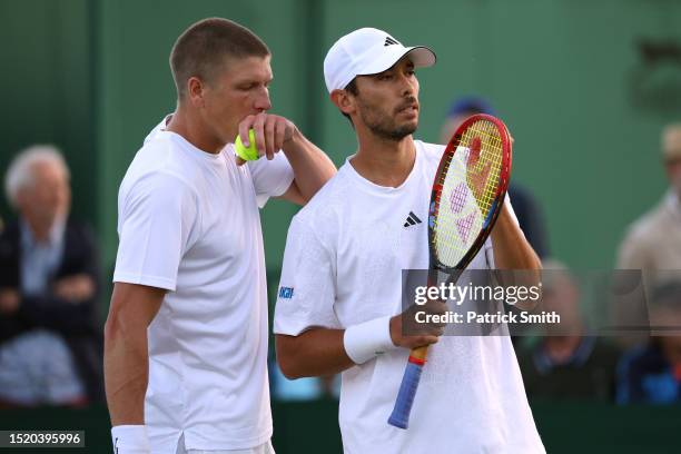 Ben McLachlan of Japan and partner Andre Goeransson of Sweden interact against Johannus Monday of Great Britain and partner Jacob Fearnley of Great...