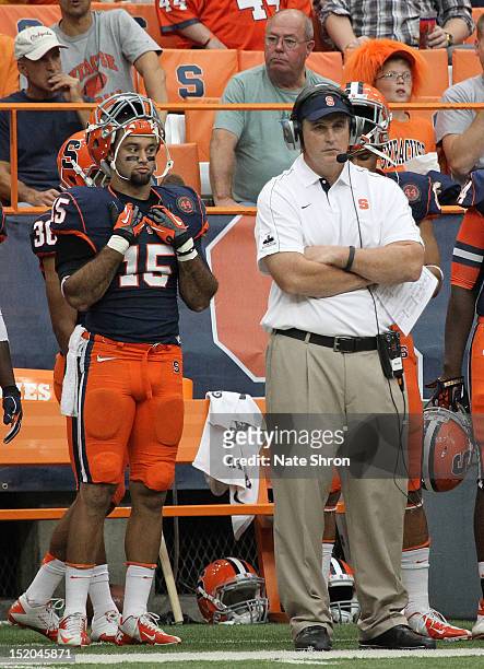 Doug Marrone, head coach of the Syracuse Orange looks on from the sideline with Alec Lemon during the game against the Stony Brook Seawolves on...