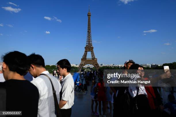 Tourists gather at Esplanade du Trocadero to watch the Eiffel Tower on July 06, 2023 in Paris, France. Paris will host the Summer Olympics from July...