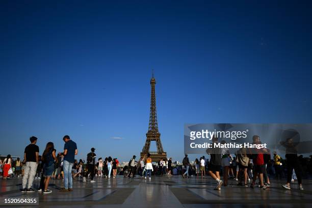 Tourists gather at Esplanade du Trocadero to watch the Eiffel Tower on July 06, 2023 in Paris, France. Paris will host the Summer Olympics from July...