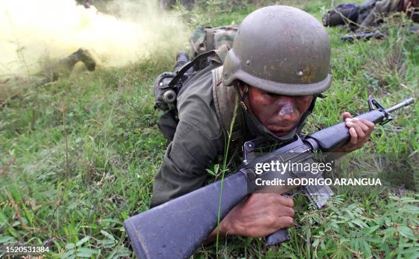 Member of the National Police, being trained by the so called "Jungle Command" for the war against drugs in Colombia is practicing an escape routine,...